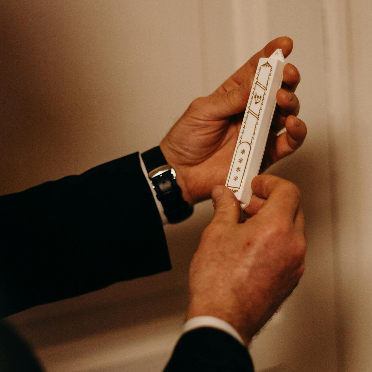 Mezuzah being affixed to a doorpost