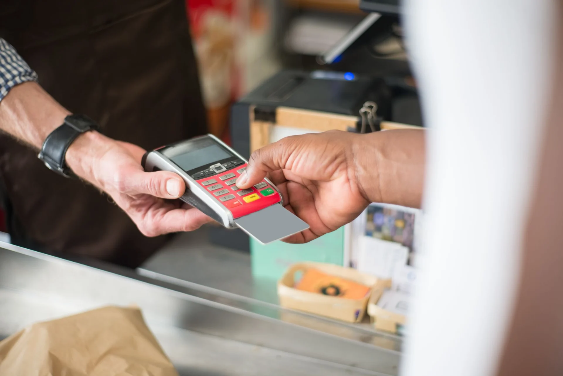 Handing a card across a shop counter