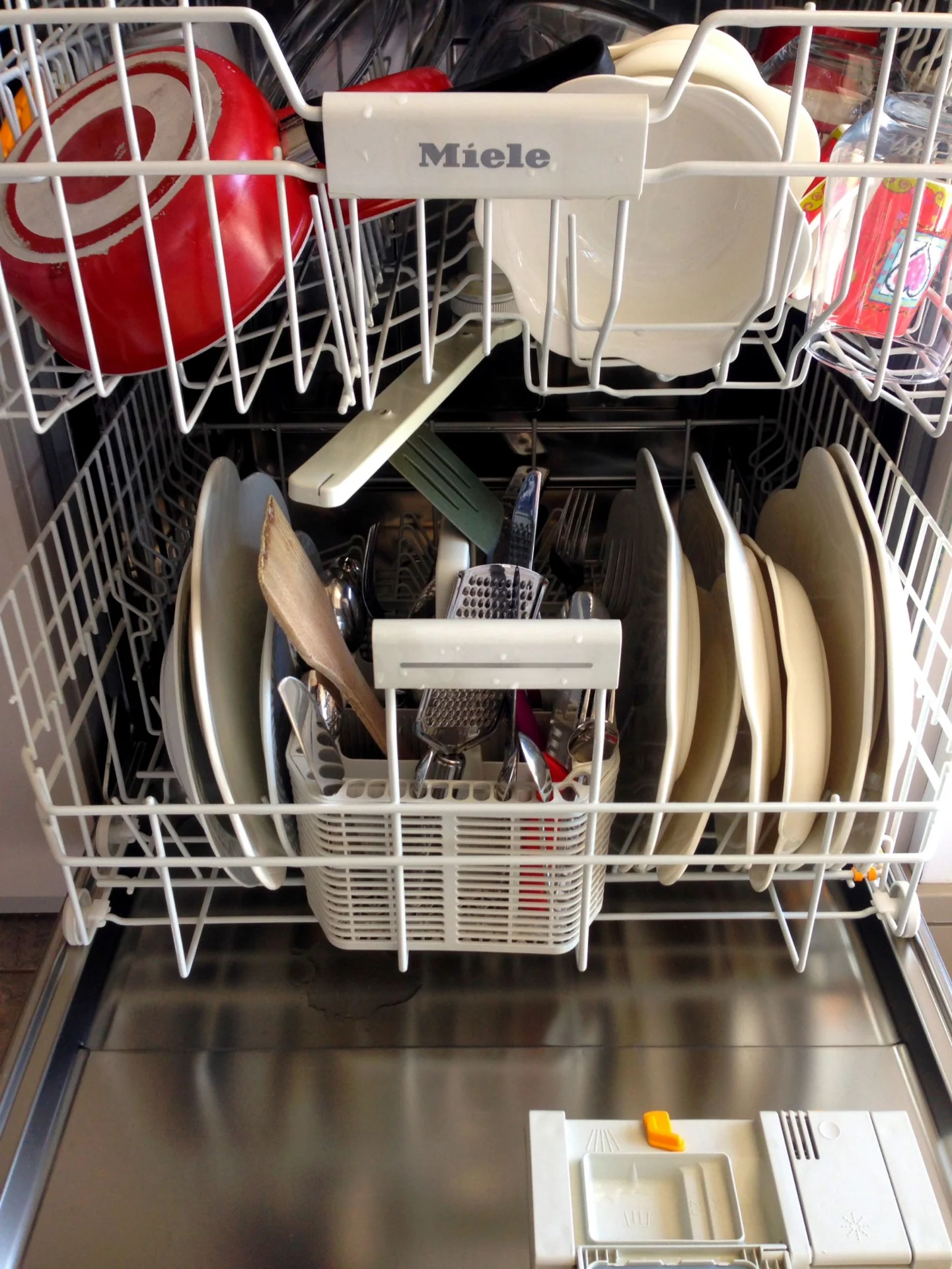 Open dishwasher loaded with dishes