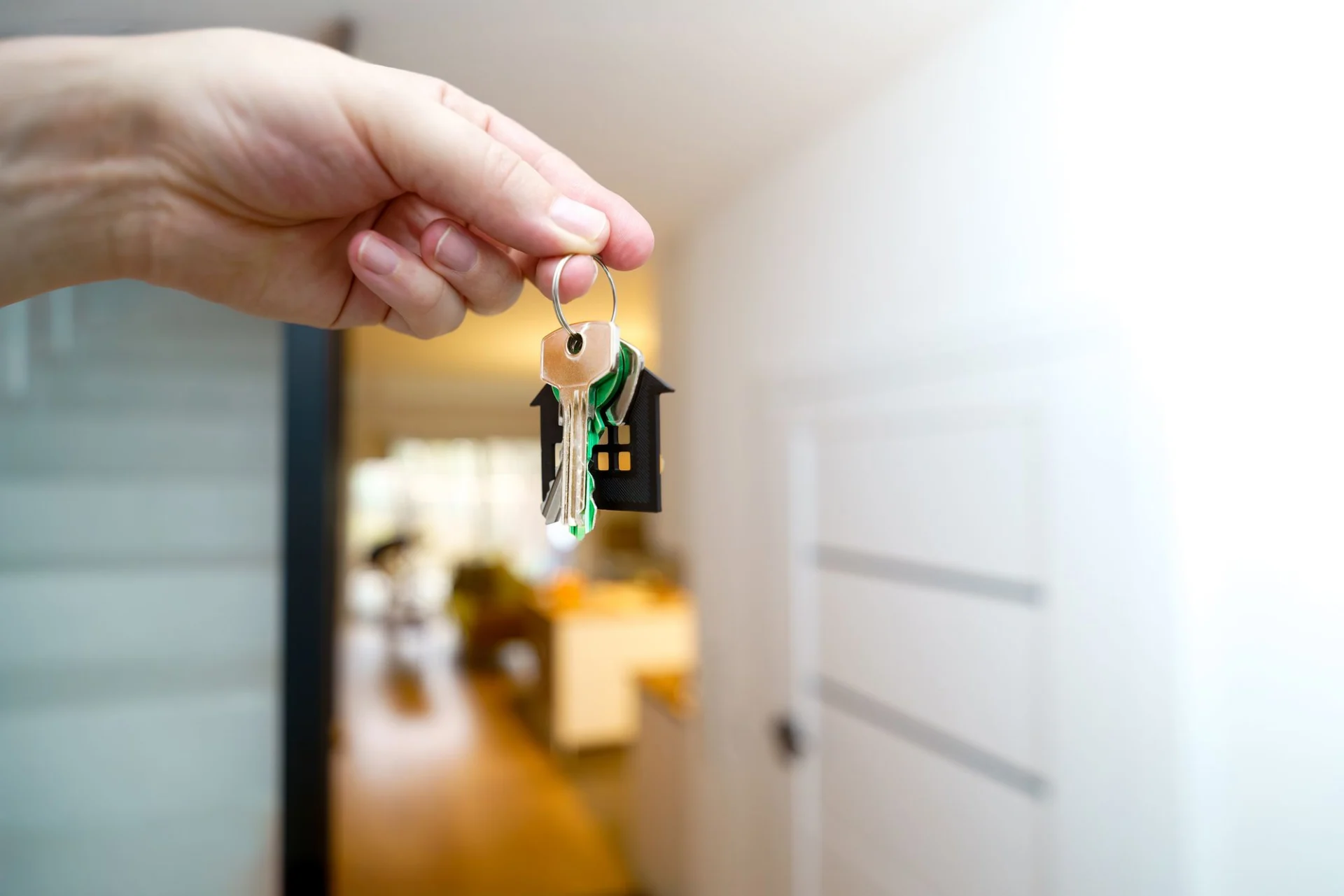Holding house keys at a doorway
